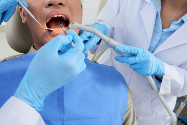 cropped-male-patient-with-mouth-open-teeth-examination-dentistry_